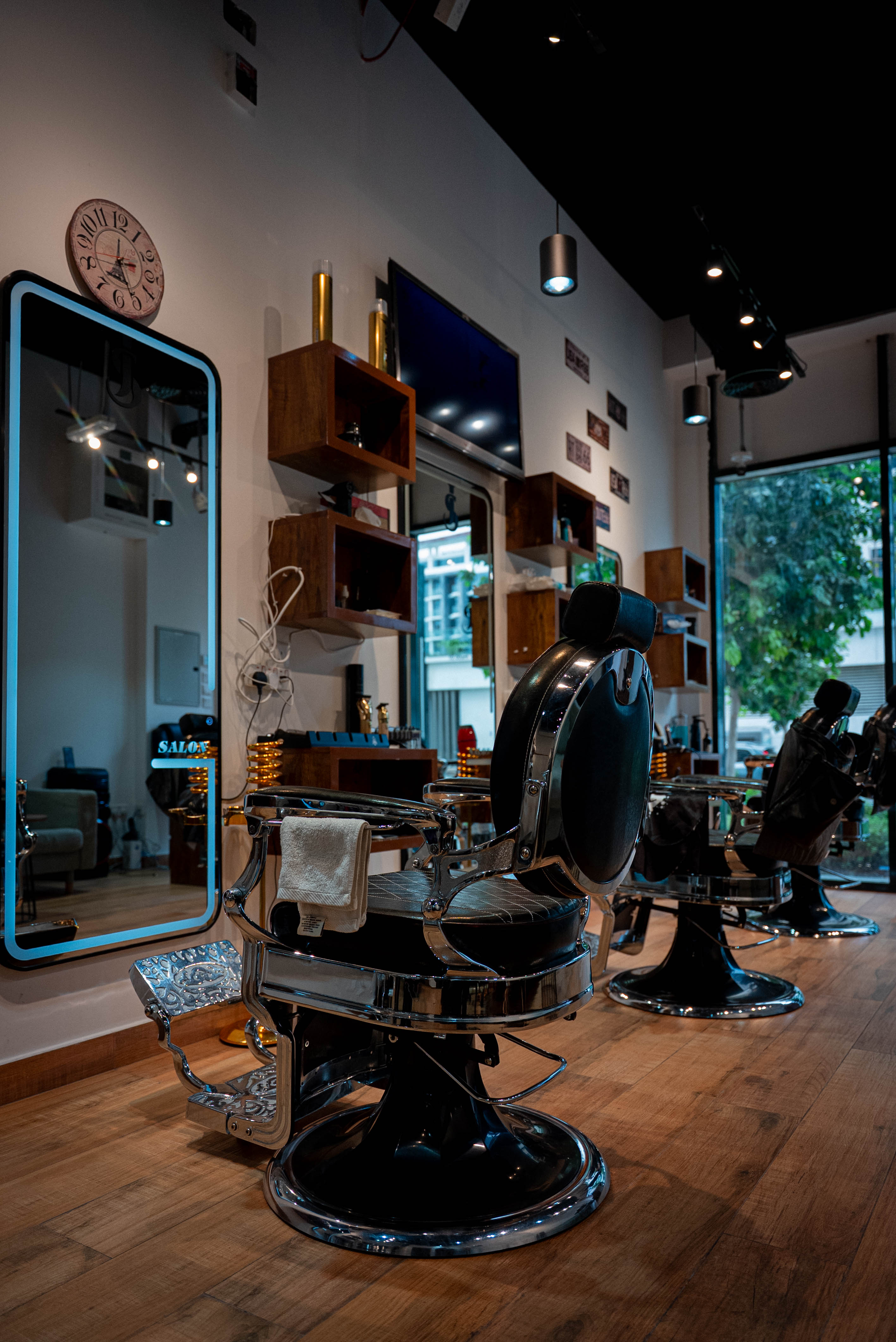 Vintage barber chair beside an illuminated mirror