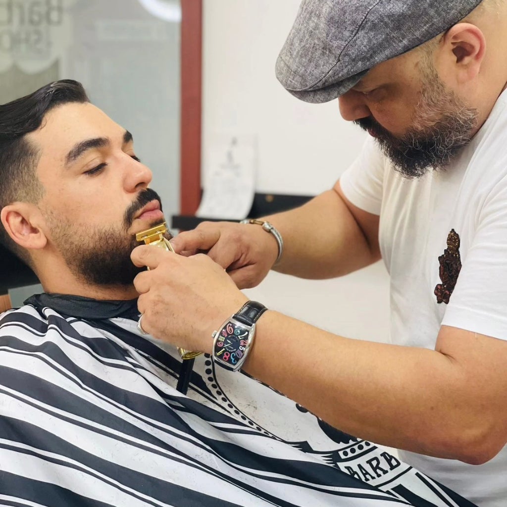 Barber sculpting a client's beard at Samih Jomni